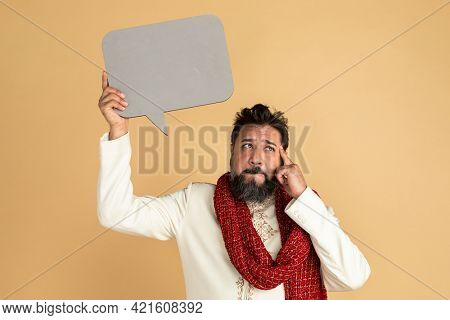 Thoughtful Indian man in a kurta holding a speech bubble mockup