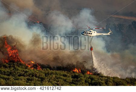 Helicopter With Bambi Bucket Over The Fire