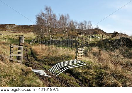 High Pennine Farmland With A Broken Gate Across A Pathway Leading To Midgley Moor In Calderdale West