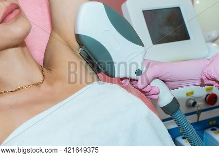 Body Care. Underarm Laser Hair Removal. Beautician Removing Hair Of Young Woman's Armpit. In Cosmeti