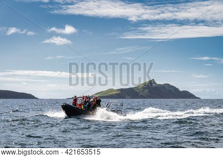 Portmagee, Ireland, August 2019 Happy Group Of Tourists Sailing On Boat To Visit Skellig Michael Isl