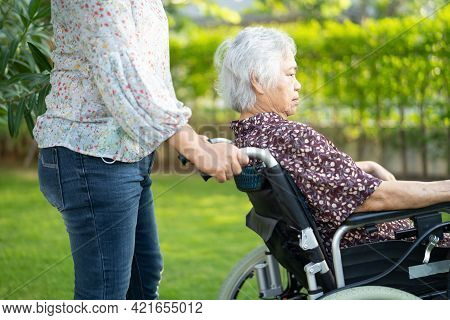 Doctor Help And Care Asian Senior Or Elderly Old Lady Woman Patient Sitting On Wheelchair At Park In