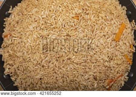 Pilaf Rice Close Up. Oriental Cuisine Concept. National Uzbek Pilaf With Meat In A Cast Iron Pan. To