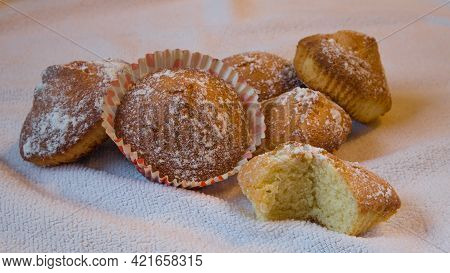 Freshly Baked Muffins Sprinkled With Powdered Sugar On A Towel