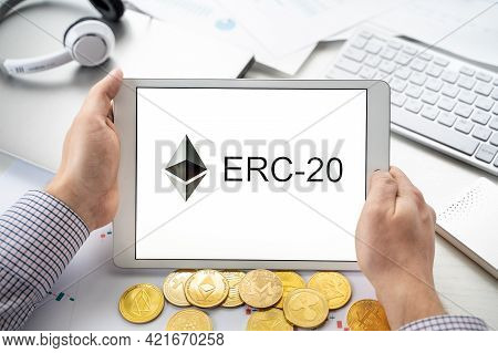 Russia Moscow 06.05.2021.businessman Holding Tablet With Logo Of Erc-20 Official Protocol Of Ethereu