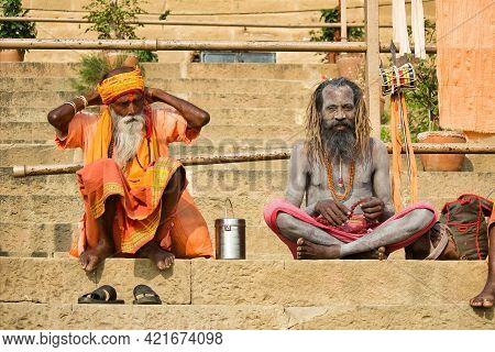 Varanasi, India - November 01, 2016: Two Hindu Bearded Sadhu, Pilgrim With Damru On Spear Sitting In