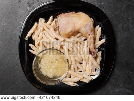 Caucasian Homemade Noodles With Chicken Leg And Garlic Sauce On A Black Plate On A Dark Background, 