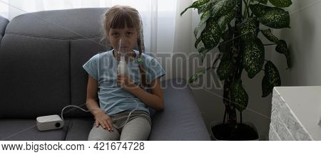 Little Girl Making Inhalation With Nebulizer At Home. Child Asthma Inhaler Inhalation Nebulizer Stea