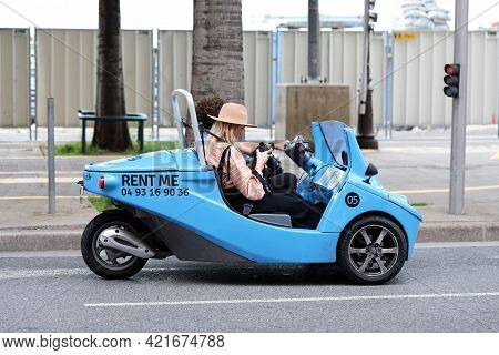 Nice, France - May 21, 2019: Young Couple Of Tourists In Small Blue Rental Car From Nicecar, Funny T