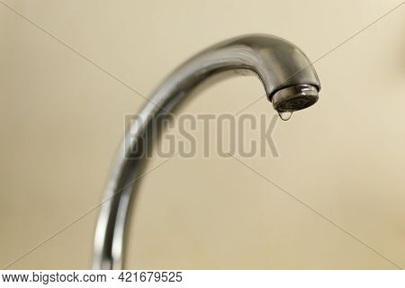Water Dripping From The Tap. Waste Water Concept. Horizontal Orientation. Copy Space. Selective Focu