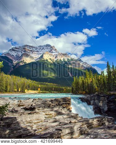 The magnificent powerful Athabasca Falls, popular with tourists. Rocky Mountains of Canada. The Athabasca River begins at the Columbia Glacier. Travel and photo tourism concept