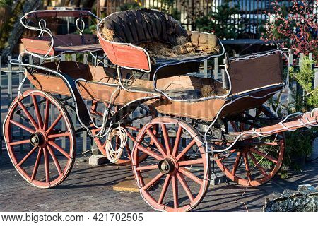 Old Carriage Outdoor Cafe Evening Sunset Outdoor Shot In The Town.the Carriage Is Lined With Garland