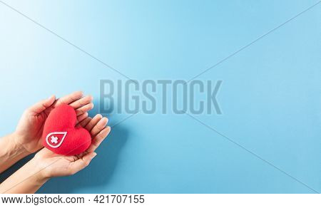 Medical And Donor Concepts. Hand Holding A Handmade Red Heart With A Sign Or Symbol Of Blood Donatio