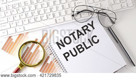 Text Notary Public .workspace With Keyboar, Notebook Sketchbook, Chart On The White Background.