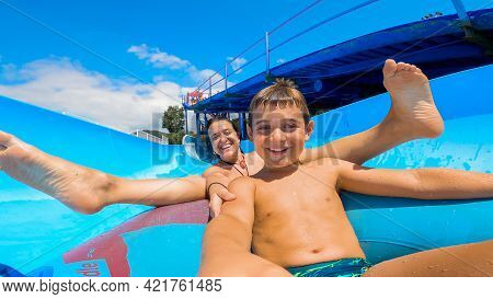 Selfie Portrait Of Son And Mother Smiling And Looking At Camera After Sliding Down A Water Slide On 
