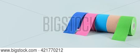 Rolls Kinesiology Tape For Athletes On Blue. Body Correction And Acceleration Of Lymph Outflow.