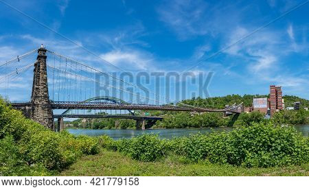 Wheeling, Wv - May 18, 2021: Old Suspension Bridge Carrying The National Road Over The Ohio River In
