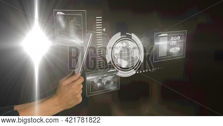 Hands holding tablet and digital interface with globe map and information on dark background. global communication technology digital interface concept, digitally generated image.