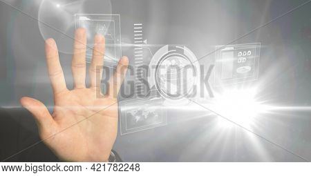 Hand using digital interface screen with network of icons, globe and charts. global business, digital interface and communication technology concept, digitally generated image.
