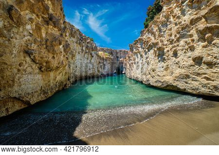 Papafragas hidden beach with crystal clear turquoise water and tunnel rock formations in Milos island, Greece