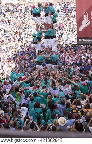 Tarragona, Spain, September 19, 2019 - Girl Climbing Human Castles Tower. Team Vilafranca Castells P