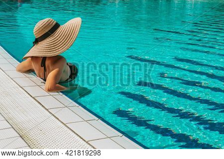 Summer Sale. Young Sexy Woman In Sun Hat, Bikini Swimsuit, Sunglasses Relaxing In Blue Pool Water. S