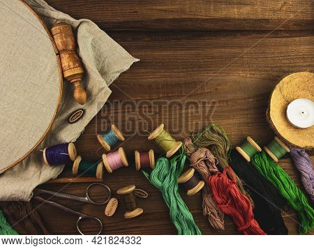 Embroidery Needlework Background With Linen In Hoop. Colorful Floss Thread, Scissors, Card Tag In Fe