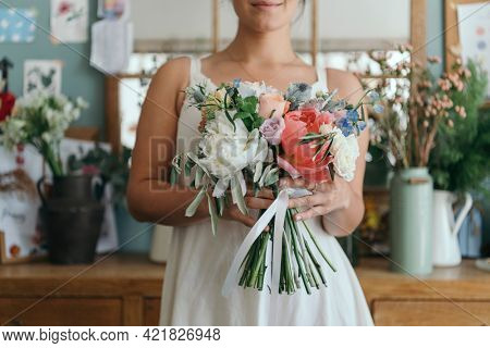 Woman carrying a beautiful flower bouquet