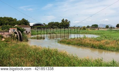 Water Wheel Pump Used To Provide Water For Orchard Irrigation