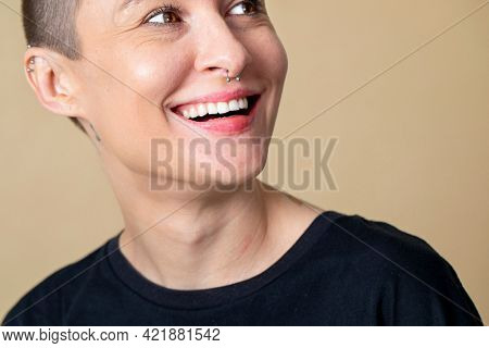 Happy skinhead woman smiling in studio shoot