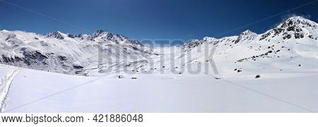 Ski Mountaineering In A Beautiful Snowy Mountain Field. Tour Above The Fluelapass In Switzerland. Pa