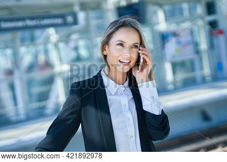 Adult female passenger using smartphone at the airport