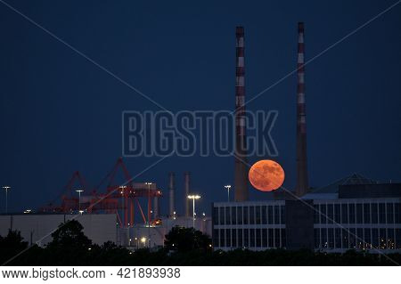 Beautiful View Of Red Super Flower Moon Rise In The Irish Sky Between Iconic Poolbeg Generating Stat