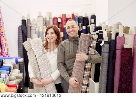 Family Business Team Working Together. Couple Of Two Professional Tailors Holding Rolls Of Fabrics C