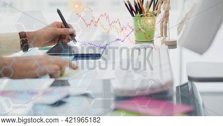 Composition of person at desk using computer and tablet with digital interface screen. global science, communication, research and digital interface concept digitally generated image.