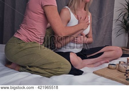 Two Women Perform Somatic Practices On A Bed In A Home Bedroom