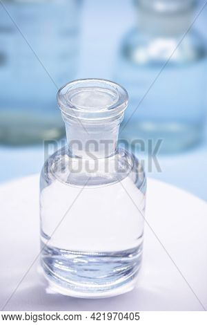 Reagent Bottle With Glass Stopper, Blue Background, Pharmacy Or Medicine Concept, With Copy Space