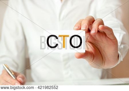 A Woman In A White Shirt Holds A Piece Of Paper With The Text: Cto. Business Concept For Companies. 