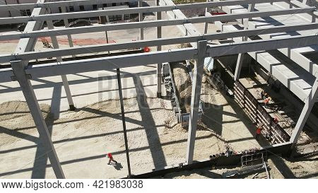 Reinforced Concrete Frame Of An Industrial Building. Camera Flight On A Construction Site. Beams Wit