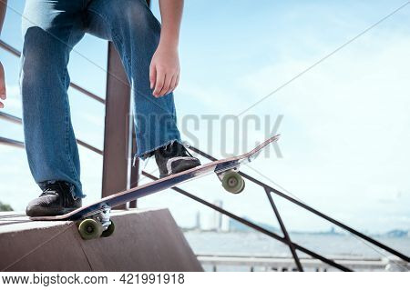 Skateboarder Jumping High On Mini Ramp At Skate Park Outdoor.