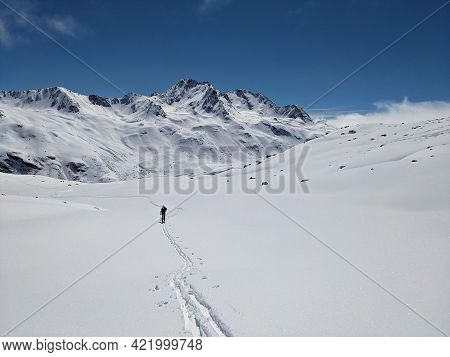 Ski Mountaineering In The Beautiful Swiss Alps. Winter Landscape In The Grisons Mountains Near The E