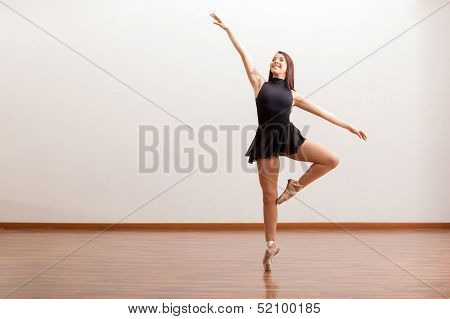 Happy ballet dancer in a studio