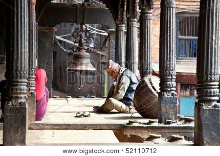 BHAKTAPUR - MAY 20 : Unidentified Tharu old man besides the street of Bhaktapur, Nepal on May 20, 2013. Tharu are an ethnic group from west part of Nepal.