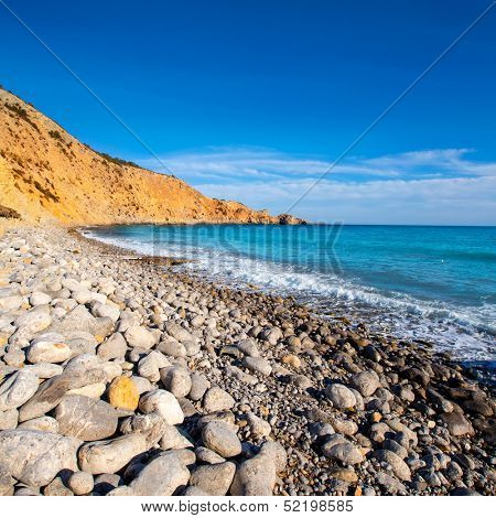 Ibiza Cala Jondal Beach with rolling stones in san Jose at Balearic Islands