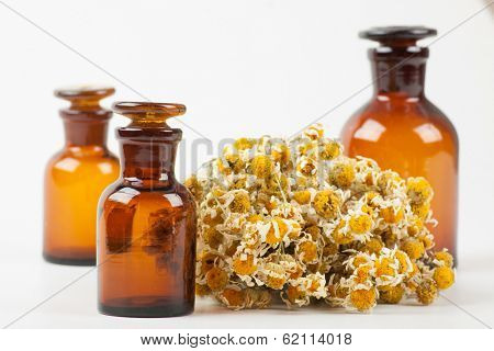 Dry chamomile and a bottles