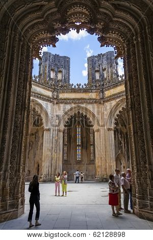 Batalha, Portugal - July 17, 2013: Tourists stroll around the interior of the Unfinished Chapels - Capelas Imperfeitas of the Batalha Monastery. UNESCO World Heritage Site.