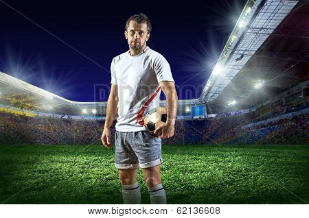 Football player with ball on field of stadium