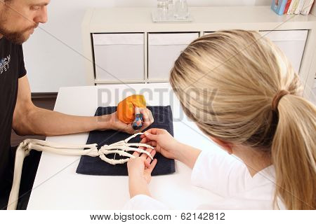 Hand Surgeon Supports A Patient With Movement Exercises