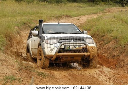 White Toyota Triton Dhd Crossing Mud Obstacle