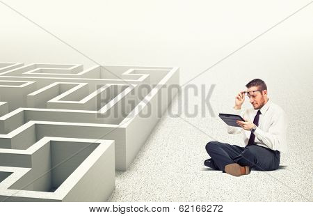 businessman use tablet 3d maze background